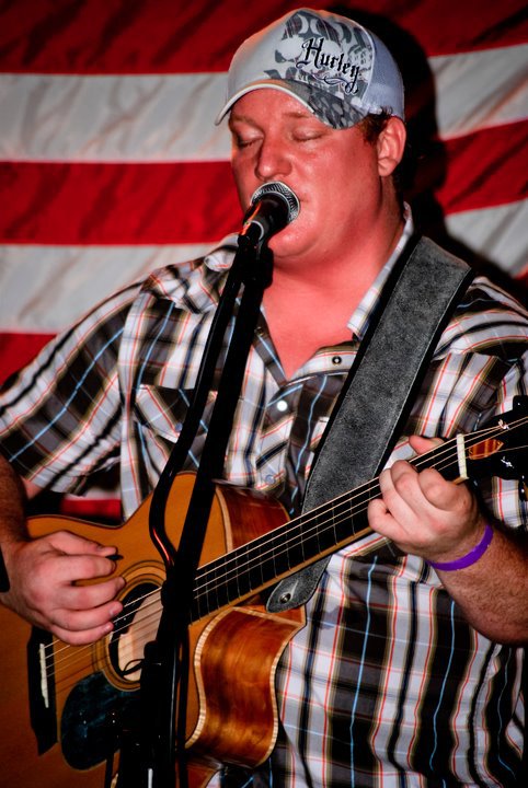 Chris Bush with acoustic guitar